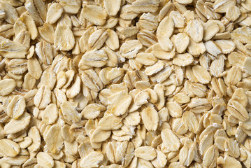 organic healthy pile of dry oat flakes, texture background.
