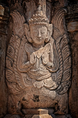 Fototapeta na wymiar Detail of a nat statue (angel of spirit) in Tharkhaung buddhist monastery near Inle lake in Burma, Myanmar