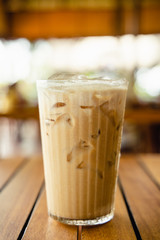 Glass of iced coffee  on wooden table.