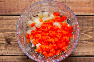 Step-by-step preparation of Olivier salad with beef, step 1 - boiled sliced potatoes and carrots, top view, selective focus