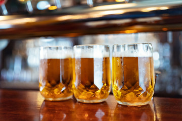 Glasses of light beer on a pub counter