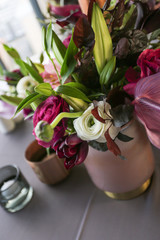 Red and white flower arrangement on the table for an event.