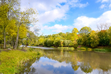 autumn landscape with river and blue sky