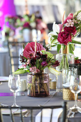Red flower arrangement on the table for an event.
