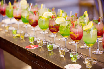 Green and red cocktails with shooter glasses, ready for guests 