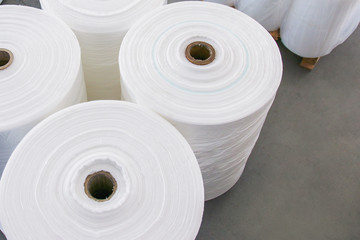 The roll of material for plastic bag manufacturing process. The plastic bag in the roll