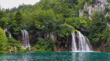 Two waterfalls flowing into a lake at Plitvice Lakes, UNESCO World Heritage Site