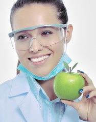 Dentist medical doctor woman hold green fresh apple in hand and tooth brush. Dentist doctors. Woman...