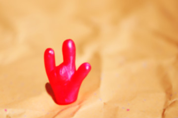 Defocused photo of a bright toy hand with 
