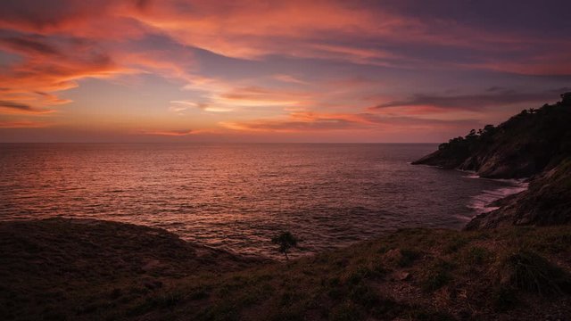 beautiful sunset on green grass coastline 4k time lapse, laem krating viewpoint at Phuket Thailand 