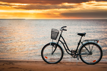 Fototapeta premium Lonely bike standing at sunset at seaside