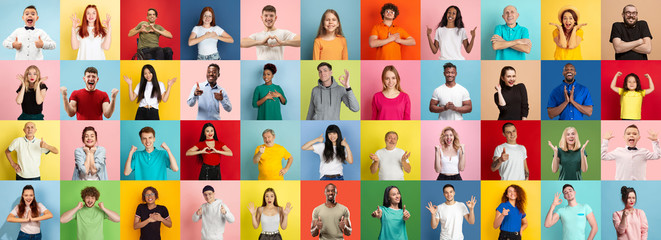 Obraz na płótnie Canvas Collage of portraits of 35 young emotional people on multicolored background. Concept of human emotions, facial expression, sales. Smiling, heart gesture, thumb up, happy, celebrating, pointing