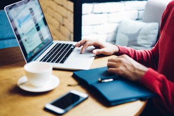 Cropped image of male freelancer working with online website system checking settings and editing...