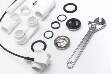 Details plastic siphon kit for bathtub on a white background. Plumbing knolling on white background