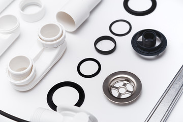 Details plastic siphon kit for bathtub on a white background. Plumbing knolling on white background