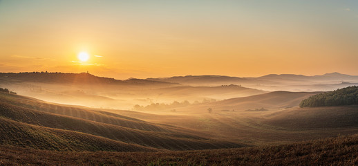 Fototapeta na wymiar Beautiful sunrise over the Tuscany hills and fields. Travel destination Tuscany