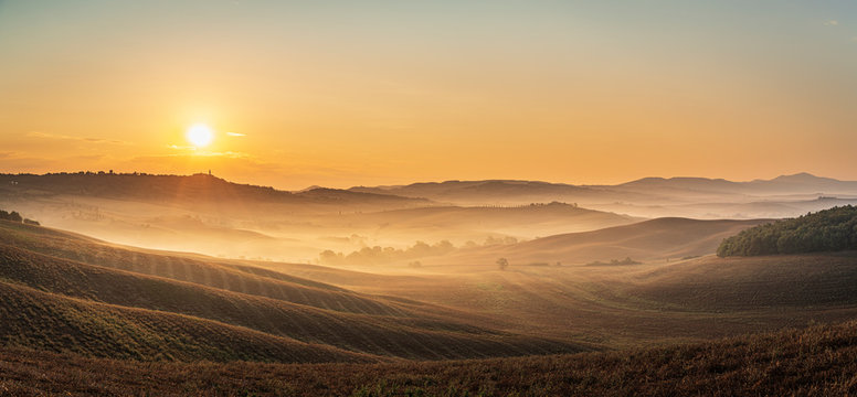 Beautiful sunrise over the Tuscany hills and fields. Travel destination Tuscany