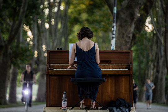 Street Artist Woman Playing Piano In German Park