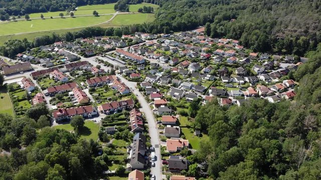Aerial drone flying above green Utby district in Gothenburg, day, forward