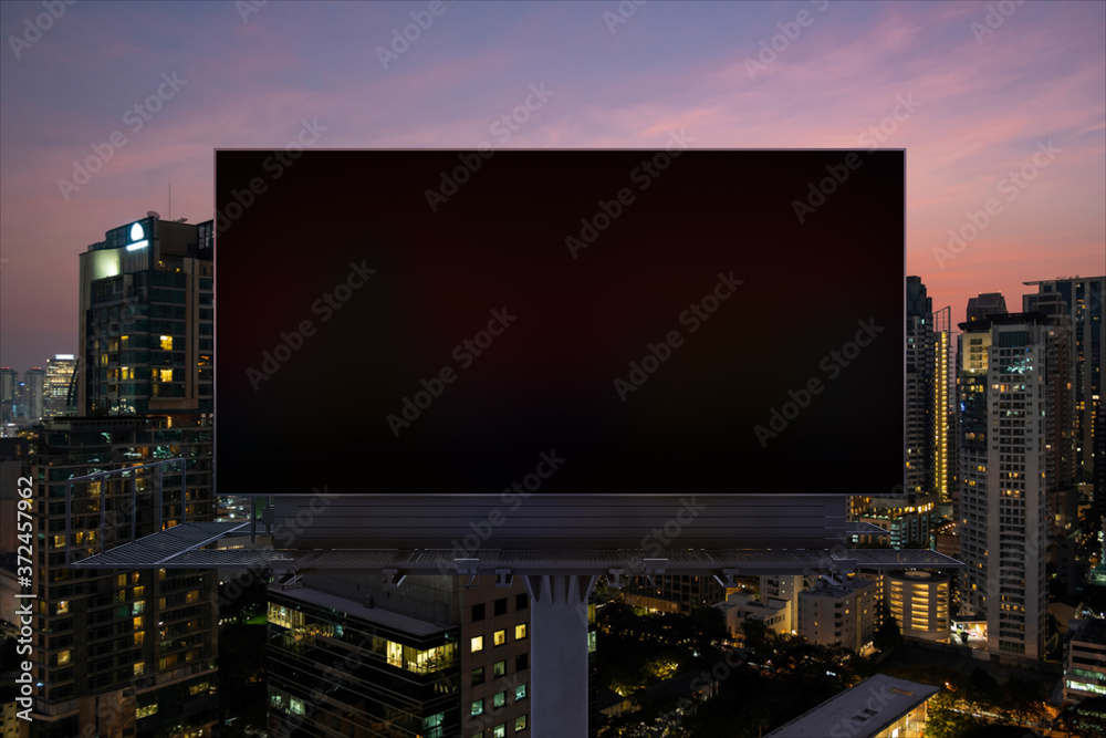 Wall mural blank black road billboard with bangkok cityscape background at night time. street advertising poste