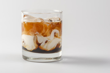Alcoholic coffee creamy cocktail in glass glass on white background