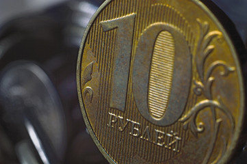 Russian coin in denomination of 10 rubles (reverse) against the background of other Russian rubles of various denominations. Macro.