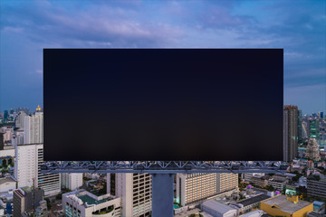 Blank black road billboard with Bangkok cityscape background at night time. Street advertising poster, mock up, 3D rendering. Front view. The concept of marketing communication to sell idea.