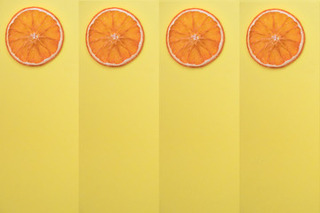Home preparation. Sliced dried orange, natural fruit chips without sugar and spices on yellow background. for text message or media and content. program. schedule .