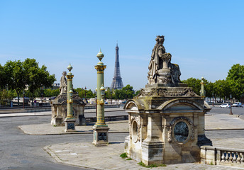 Fototapeta na wymiar Statues de Lyon and Marseille on place de la Concorde in summer with the Eiffel Tower in the background - Paris, France.