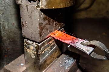 Forging molten metal. Making knives.