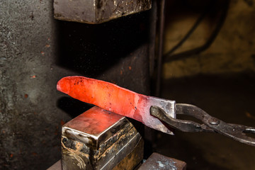 Forging molten metal. Making knives.