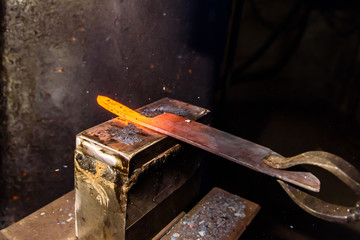 Forging molten metal. Making knives.