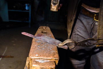 Forging molten metal. Making knives.