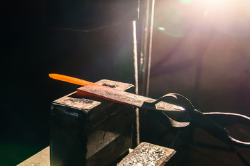 Forging molten metal. Making knives.