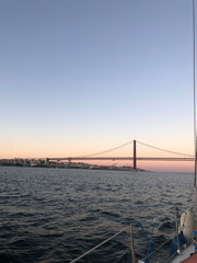 Ponte 25 de Abril Lisbon at sunset from water