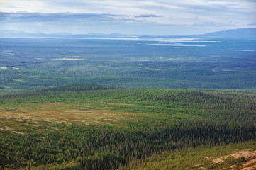 Obraz premium Scenic view of beautiful landscape with forest, hills and sky clouds