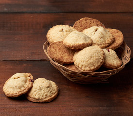 baked round cookies in a wooden round plate on the table