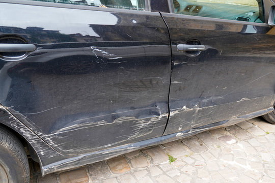 Car side is scratched and scraped with deep damage on accident to the paint