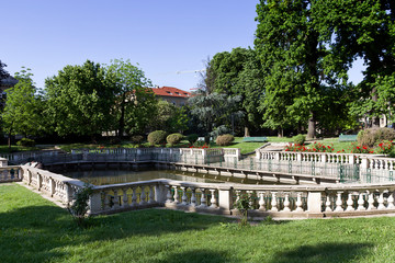 Milan - Guastalla Garden, view on the baroque fishpond enclosed by an elegant granite balustrade. Lombardy

