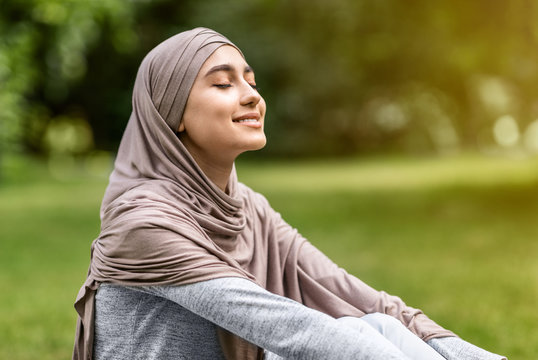 Carefree arab girl taking sunbath at park
