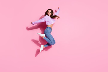 Full length photo of candid pretty girl jump enjoy free time holiday wear good look pullover isolated over pink color background