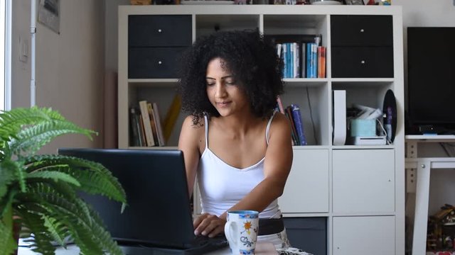 woman teleworking at home while her children playing