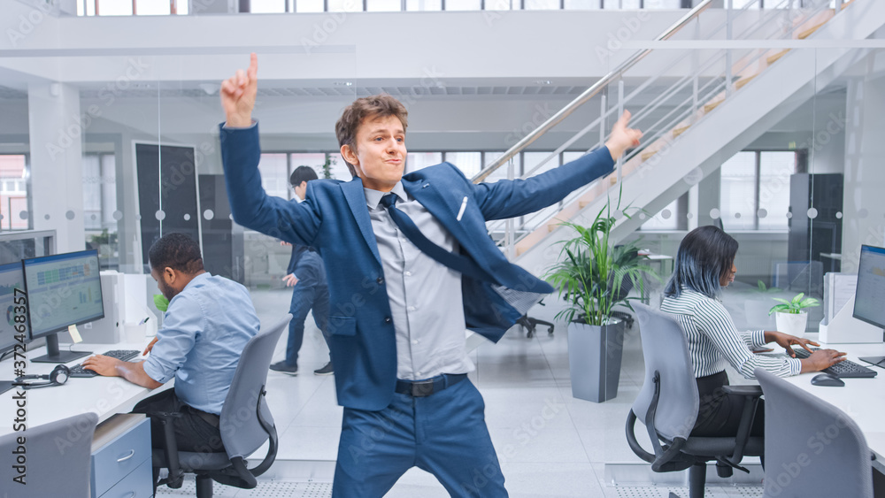 Aufkleber young cheerful handsome business manager wearing a suit and tie dancing in the office. diverse and m