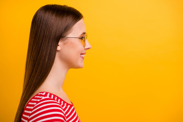 Closeup side photo of pretty lovely young girl beaming smiling look empty space promising promotion sales shop opening wear sun specs striped white red shirt vibrant yellow color background