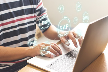 Close-up image of male hands working on laptop. Business management software (SAP). ERP enterprise resources planning system concept - obrazy, fototapety, plakaty