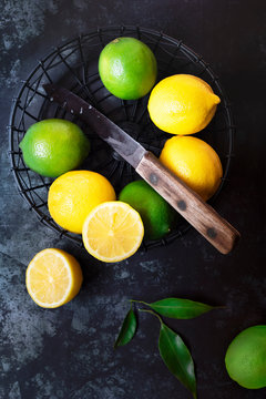 Lemons and limes in a wire basket.