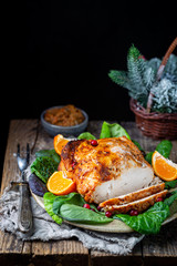 Delicious sliced turkey breast for Thanksgiving Day table on wooden board