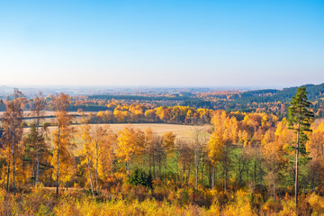Aerial view at a beautiful autumn landscape with fields and forests