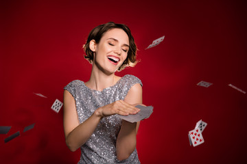 Photo of attractive excited lady las vegas casino club member professional throwing cards air...