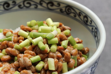 Natto, fermented soybeans on steamed rice in bowl, close-up